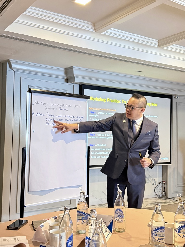 Gilbert Chan leading a workshop session — coaching leaders through real-world scenarios